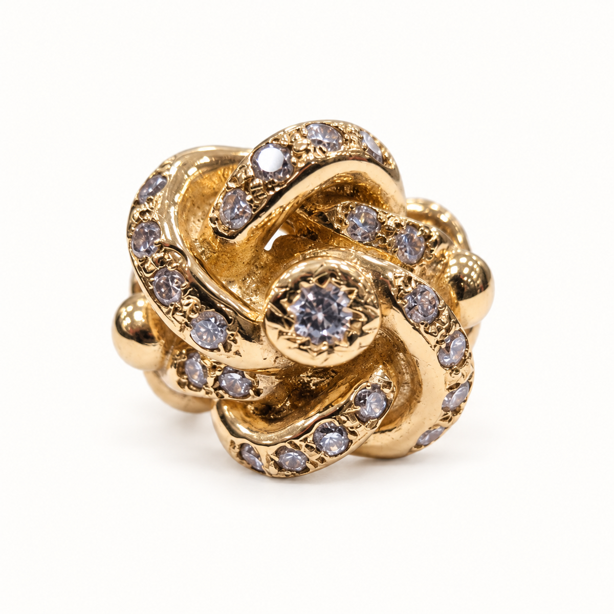 9ct gold lovers knot CZ ring, front view on ivory