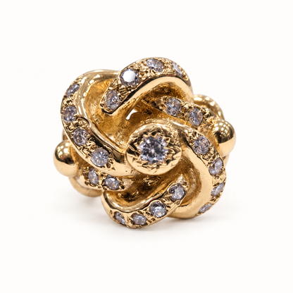 9ct gold lovers knot CZ ring, front view on ivory