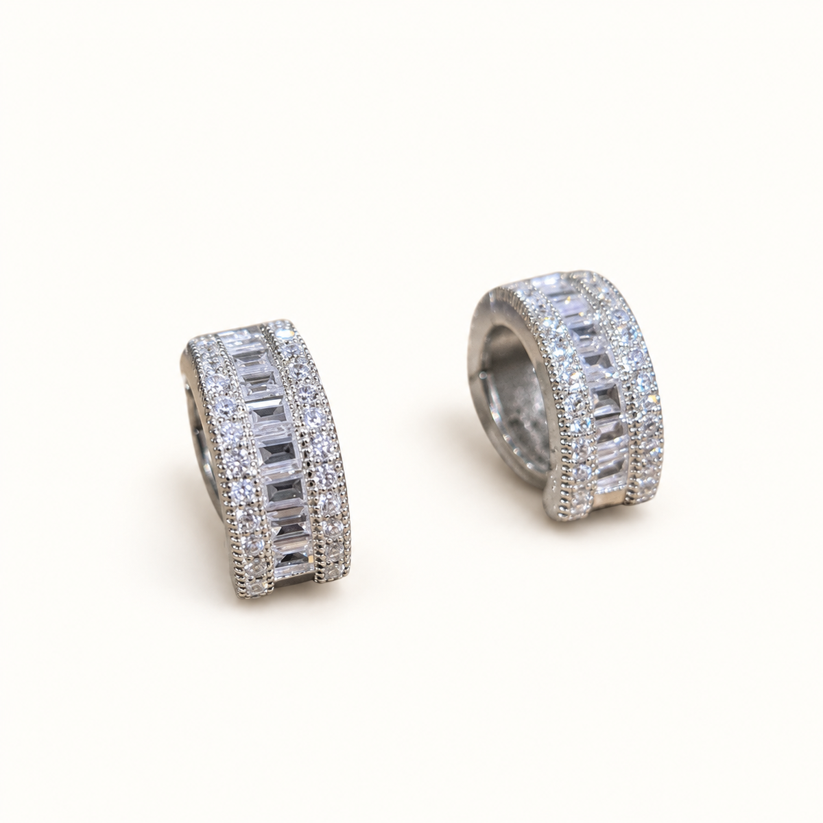 Small silver CZ hoop earrings on pale ivory