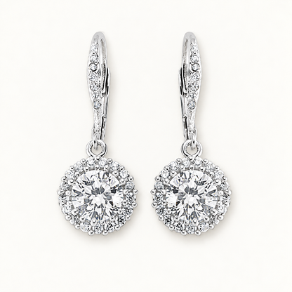Silver CZ drop earrings on ivory background